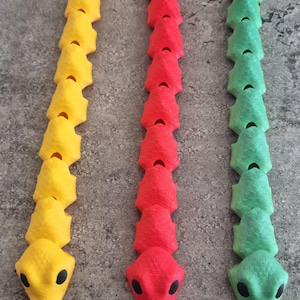 Figet snake 3d printed toy comes in 3 different colours.