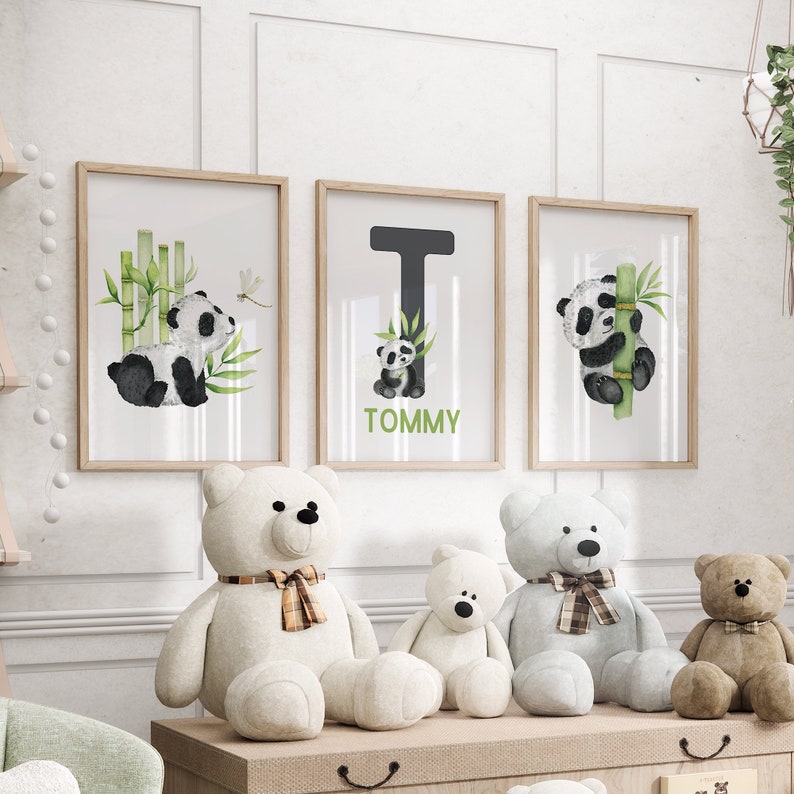 May include: Three framed prints with watercolor illustrations of pandas and bamboo. The middle print features the letter T and the name Tommy. Three plush teddy bears are sitting in front of the prints.