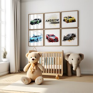 May include: A nursery room with a crib, a teddy bear, and an elephant toy. There are six framed watercolor paintings on the wall, each featuring a different race car. One of the paintings has the name "ANDREW" written on it.