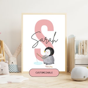 May include: A pink letter S with the name Sarah written in cursive below it. A penguin is fishing in a small ice hole. The text "CUSTOMIZABLE" is on a pink button at the bottom of the image.