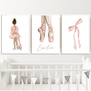 May include: Three watercolor prints featuring a ballerina in a pink tutu, a pair of pink ballet shoes, and a pink ribbon bow. The middle print includes the name "Emilia".