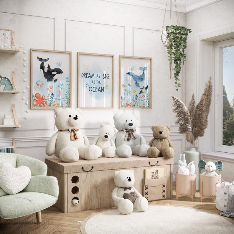 May include: A nursery scene with framed artwork depicting marine life and the phrase "Dream as big as the ocean." Several teddy bears are arranged on a wooden chest. A mint green armchair and hanging plants add to the room's decor.