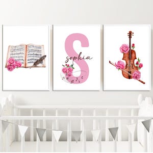 May include: Three framed prints with a musical theme. The first print features a vintage sheet music book with a feather and pink roses. The second print features a pink letter S with musical notes and the name "Sophia". The third print features a violin with pink roses.
