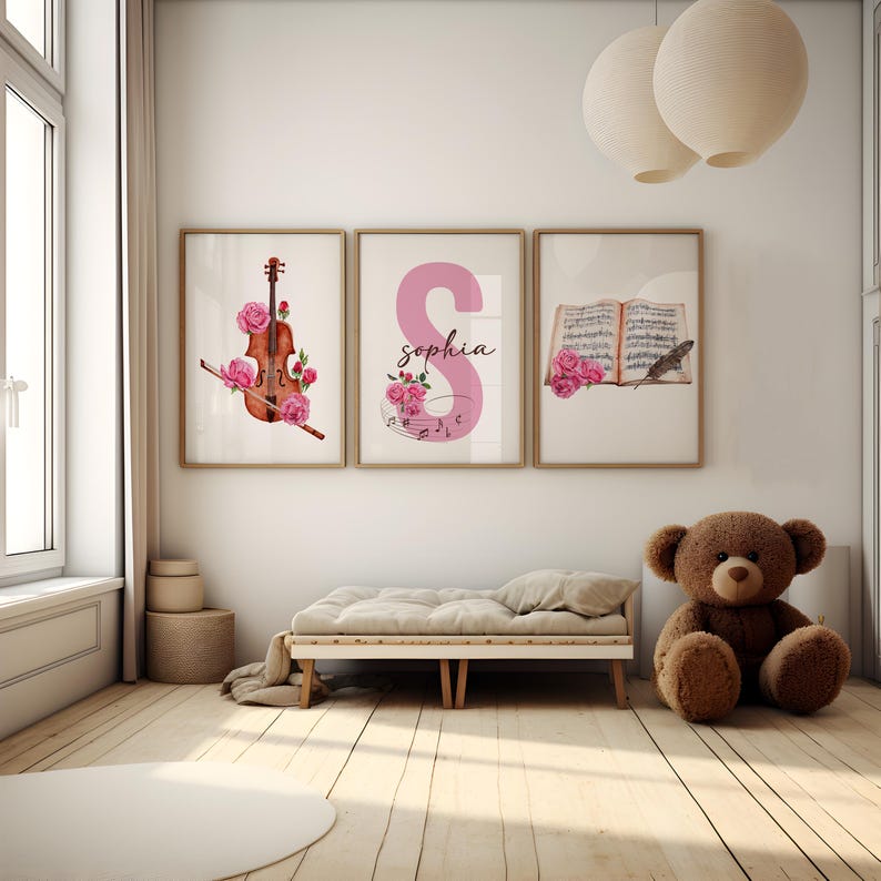 May include: Three framed prints with a watercolor design. The first print features a violin with pink roses, the second print features the letter S in pink with the name "sophia" written below, and the third print features a book with musical notes and a bird with pink roses.