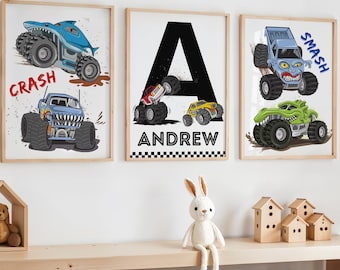 May include: Three framed prints featuring monster trucks with the words "Crash", "Smash", and "Andrew" on each print. The prints are on a wooden shelf with a white rabbit toy in front of them.