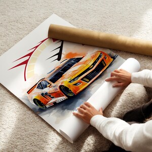 May include: Watercolor painting of an orange and yellow race car with black accents. The artwork is on a white canvas, with a brown paper tube and a rolled white paper tube nearby. The image is on a light-colored carpet.