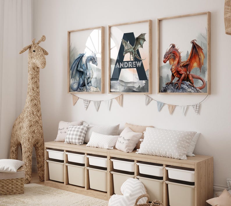 May include: Three framed dragon art prints in a child's room. The prints feature a blue, green, and red dragon. The middle print has the name "Andrew" on it. A woven giraffe and storage bench with pillows and bins are in the room.