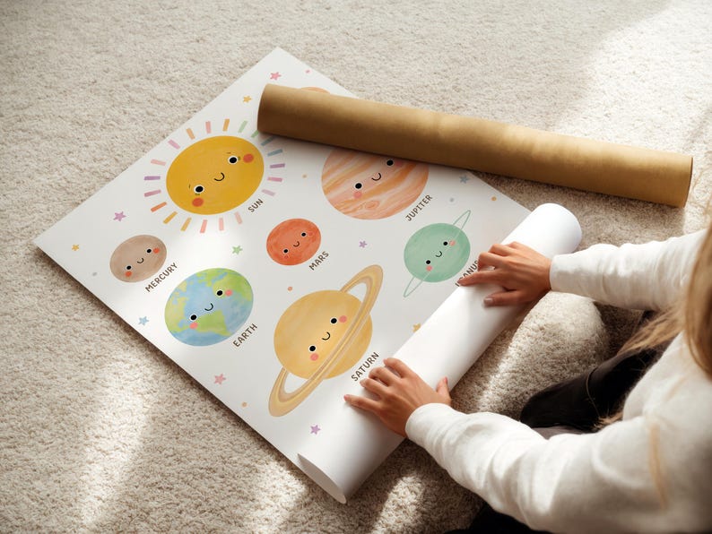 May include: A colorful educational poster featuring the planets of the solar system with smiling faces. The poster includes the sun, Mercury, Earth, Mars, Jupiter, Venus, and Saturn. A rolled-up poster and a brown tube are also visible.