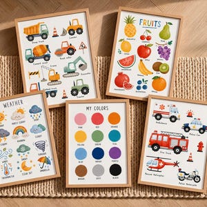 May include: A set of five educational wall art prints in light wood frames. The prints feature colorful illustrations of construction vehicles, various fruits labeled 'FRUITS', weather conditions labeled 'WEATHER', a color chart labeled 'MY COLORS', and emergency vehicles.