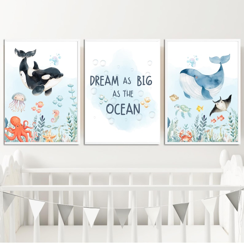 May include: A set of three framed watercolour prints with an ocean theme. One print shows a black and white orca, another has the text "Dream as Big as the Ocean", and the third depicts a blue whale. The prints include various sea creatures.