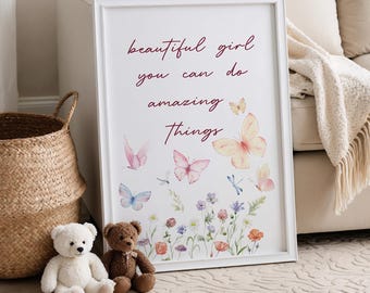 May include: White framed print with the text "beautiful girl you can do amazing things" in burgundy script. Watercolor butterflies and flowers are scattered around the text.