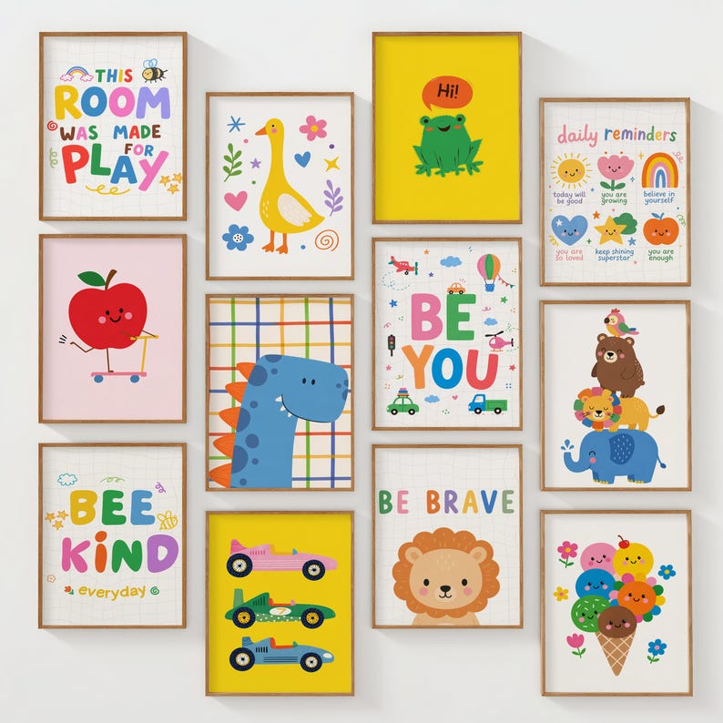 May include: A collection of framed art prints with colorful illustrations. The prints feature various themes, including a dinosaur, a lion, an apple, a frog, and inspirational quotes like "Be You" and "Be Brave." The artwork is designed for children's rooms.