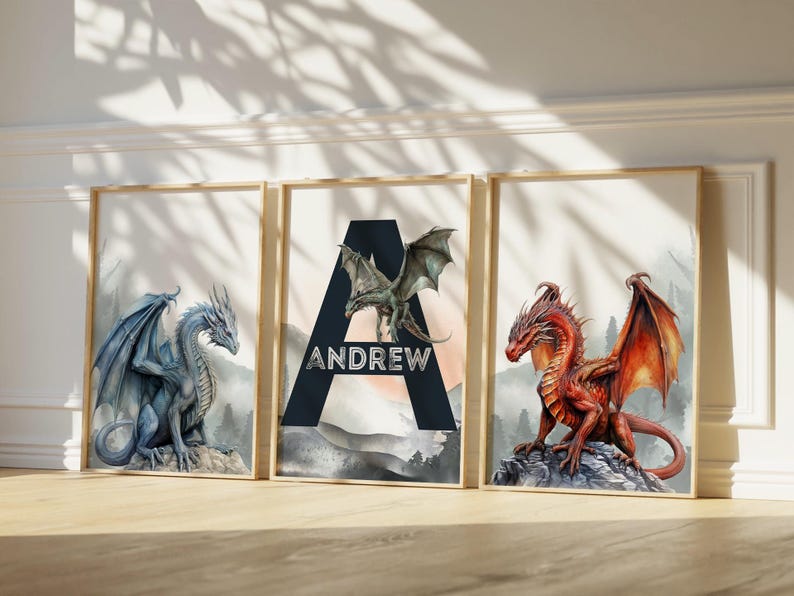May include: Three framed art prints featuring dragons. One print shows a blue dragon, another has a red dragon, and the center print displays the name "ANDREW" with a green dragon. The prints have a watercolor style.