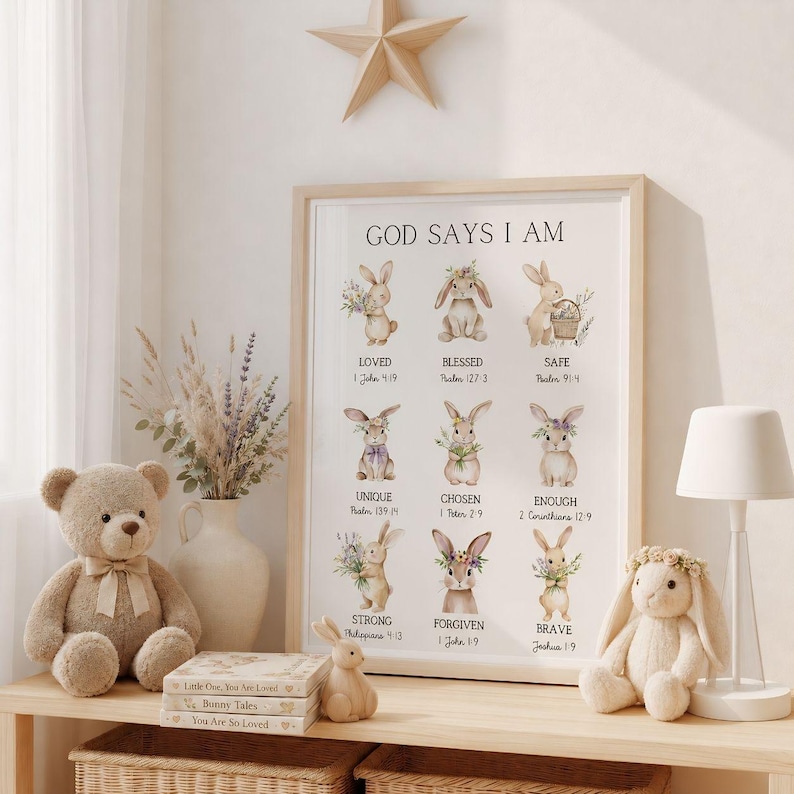 May include: A framed print with the text "GOD SAYS I AM" and illustrations of bunnies, along with inspirational words. A teddy bear, a bunny figurine, and a stuffed bunny with a floral crown are on a shelf. A star-shaped wooden decoration is above.