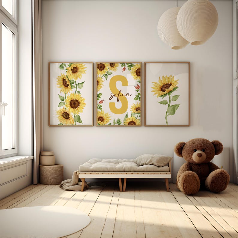 May include: Three framed prints with a sunflower theme. The center print features a large yellow letter "S" with the name "sofia" written below it. The prints are surrounded by a border of sunflowers and leaves.