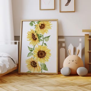 May include: A framed print featuring a watercolor illustration of a vertical arrangement of yellow sunflowers with green leaves on a white background.