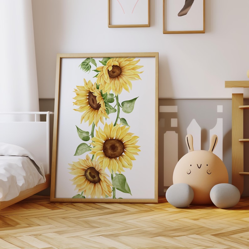 May include: A framed print featuring a watercolor illustration of a vertical arrangement of yellow sunflowers with green leaves on a white background.