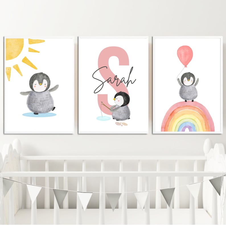 May include: Three watercolor prints featuring a penguin with a sun, a penguin fishing, and a penguin on a rainbow. The middle print has the name "Sarah" written in black.