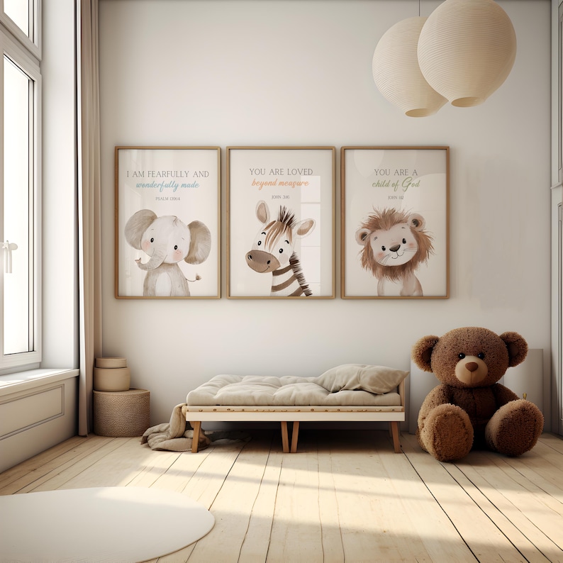 May include: Three framed prints with inspirational quotes and animal illustrations. The prints feature an elephant, a zebra, and a lion. The prints are hung on a white wall above a wooden bench. A brown teddy bear sits on the floor in front of the bench.