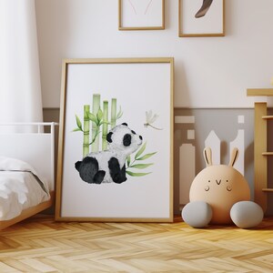 May include: A watercolor illustration of a panda bear sitting near a bamboo forest with a dragonfly flying above. The panda is black and white and the bamboo is green. The background is white.