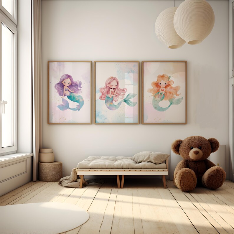 May include: Three watercolor illustrations of mermaids with different colored hair and tails. The mermaids are sitting on a light blue background with white and pink accents.