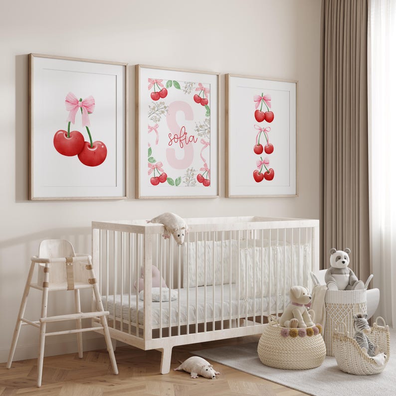 May include: Three framed prints with a cherry theme. The center print features a pink letter S with the name "Sofia" written below. The left print shows two red cherries with a pink bow. The right print shows a vertical row of red cherries with pink bows.