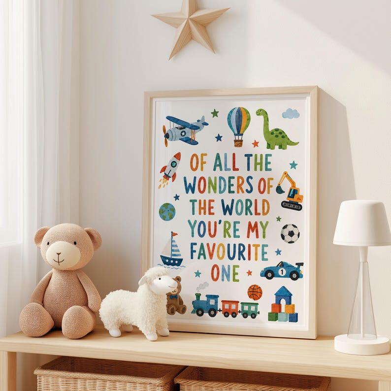 May include: A framed wall art print featuring the text OF ALL THE WONDERS OF THE WORLD YOU'RE MY FAVOURITE ONE surrounded by colorful illustrations of an airplane, hot air balloon, dinosaur, rocket, globe, sailboat, excavator, soccer ball, car, train, and blocks.