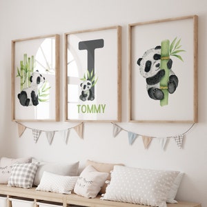 May include: Three framed prints with a watercolor illustration of a panda bear. The middle print features the letter T and the name Tommy. The print on the left shows a panda bear sitting next to bamboo. The print on the right shows a panda bear climbing a bamboo stalk.