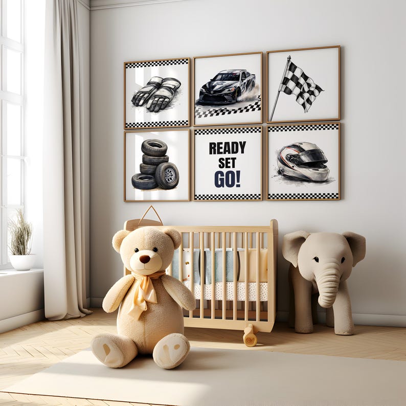 May include: Six framed racing-themed prints. The prints feature a checkered flag, racing gloves, a race car, tires, a helmet, and the text "READY SET GO!". A teddy bear and an elephant toy are in front of a wooden crib.