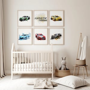 May include: A set of six watercolor prints featuring race cars in various colors, including blue, red, green, and yellow. The prints are framed in white and arranged in a grid pattern on a white wall. The name "ANDREW" is printed on one of the prints.