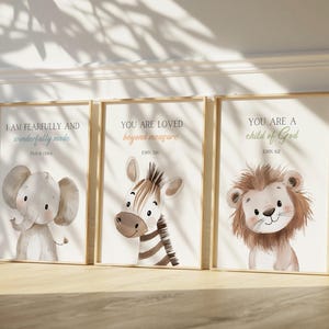 May include: Three framed prints with inspirational quotes and animal illustrations. The prints feature a brown elephant, a zebra with black and white stripes, and a brown lion. The quotes are "I am fearfully and wonderfully made", "You are loved beyond measure", and "You are a child of God".