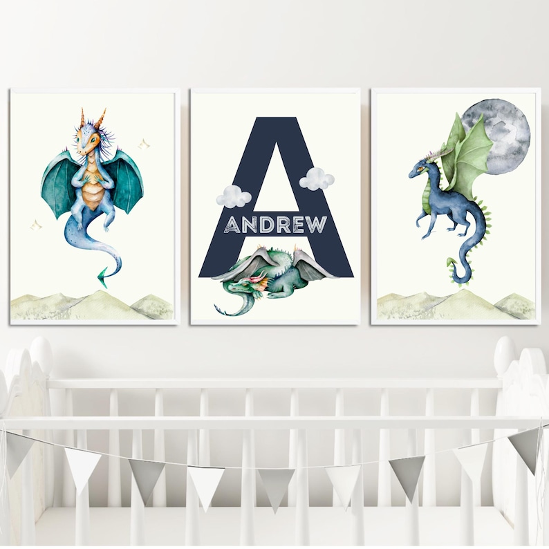 May include: Three watercolor prints featuring a blue dragon, the letter A in navy blue with the name Andrew, and a green dragon with a moon in the background.