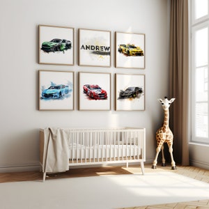 May include: A nursery room with a white crib and a stuffed giraffe toy. Six framed watercolor paintings of race cars are on the wall, with one frame featuring the name "ANDREW".
