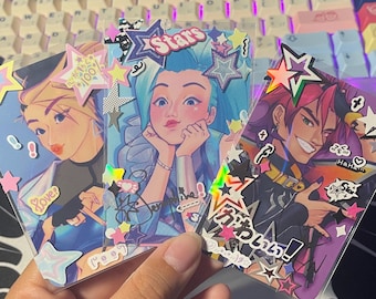 May include: Three colorful illustrated cards with holographic accents. The cards feature anime-style characters with stars and other decorative elements. The text on the cards reads "Stars", "Love?", and "がんばれ!"
