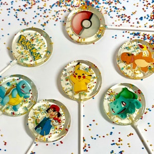 May include: Assortment of round lollipops with various Pokemon characters printed on them. The lollipops are clear and have a sparkly finish. The characters include Pikachu, Bulbasaur, Charmander, Squirtle, and a Pokeball.