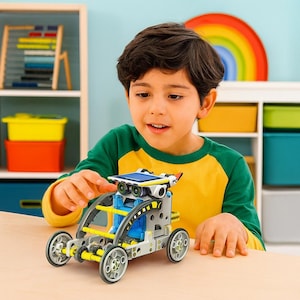 May include: A child is playing with a solar-powered robot car. The toy has a solar panel, a grey and yellow frame, blue details, and four wheels. The child is wearing a yellow and green top.