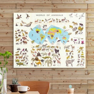 May include: A rectangular wall poster titled World of Animals featuring a central light blue world map surrounded by numerous detailed illustrations of various animals, including mammals, birds, and reptiles, arranged across a cream-colored background.