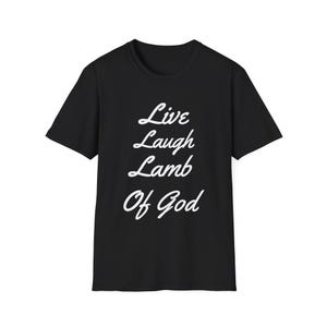 May include: Black t-shirt featuring the white script text "Live Laugh Lamb Of God". The tee has a crew neck and short sleeves. A simple, everyday garment with a religious message.