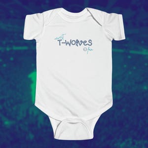 May include: White baby onesie with the text "newest T-Wolves fan" in blue.