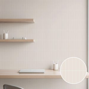May include: A neutral-toned office space featuring a light wood desk and shelves against a vertical-striped wall. A closed laptop, pencils, and a notebook are visible. The color palette is soft and minimalist.