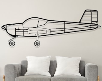 May include: Black metal outline of a small airplane mounted on a white wall above a gray couch and a wooden chair. The airplane is in flight position with the wings spread out.