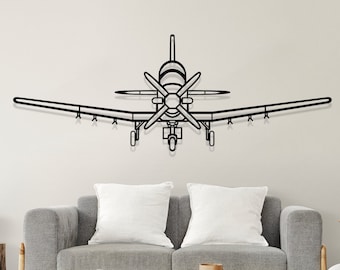 May include: A black metal airplane wall decor with a propeller and wings. The airplane is mounted on a white wall above a gray couch and a wooden coffee table.