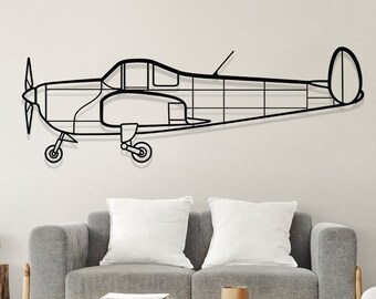 May include: Black metal wall art of a vintage airplane silhouette. The airplane is shown in profile with the wings spread and the propeller in the front. The art is displayed on a white wall above a gray couch and a wooden coffee table.