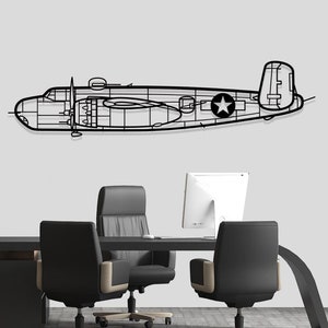 May include: A black metal cutout of a B-25 bomber plane with a star on the side, hanging on a white wall above a black desk with three black office chairs.