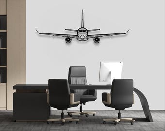 May include: Black metal airplane wall art. The airplane is depicted in a minimalist style, with a focus on the outline of the aircraft. The art piece is mounted on a white wall above a desk in an office setting.
