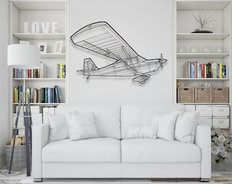 May include: A black metal airplane wall art piece. The artwork is a line drawing of a small aircraft, mounted on a white wall above a white sofa. The airplane has a propeller and detailed wings.