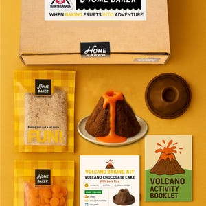 May include: A Home Baker volcano baking kit with a chocolate cake and lava fizz. The kit includes ingredients and instructions for a fun baking activity. The box contains a volcano-shaped cake, orange candy melts, and a booklet.