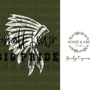 May include: Green and white graphic design with the text "Small Town Big Pride" and a white headdress with a distressed look. The design is on a green background. The text "Addie & Abe Transfers" and "Ready to press" are also included in the image.