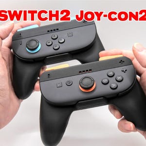 May include: Two black Switch Joy-Con controllers with blue and orange accents. The controllers have buttons, joysticks, and directional pads. The text "SWITCH2 JOY-CON2" is displayed in red at the top of the image.