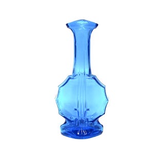 May include: A tall, elegant blue glass vase with a unique, scalloped design. The vase has a slender neck and a flared base, showcasing a vibrant, transparent blue color. The overall height is approximately 8 inches.